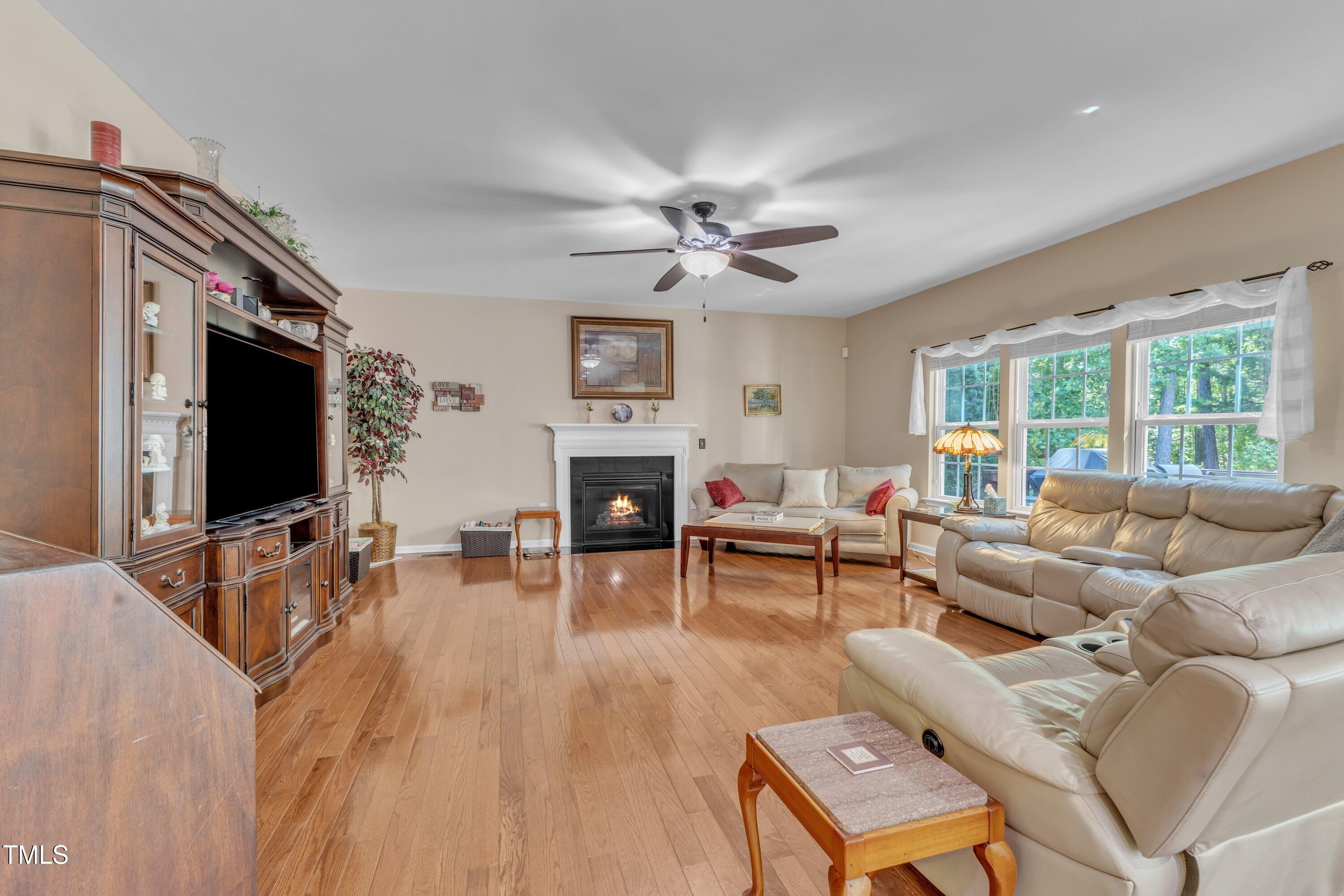 533 Opposition Way Wake Forest, NC 27587 - Photo 20 of 87 a living room with furniture a fireplace and a flat screen tv