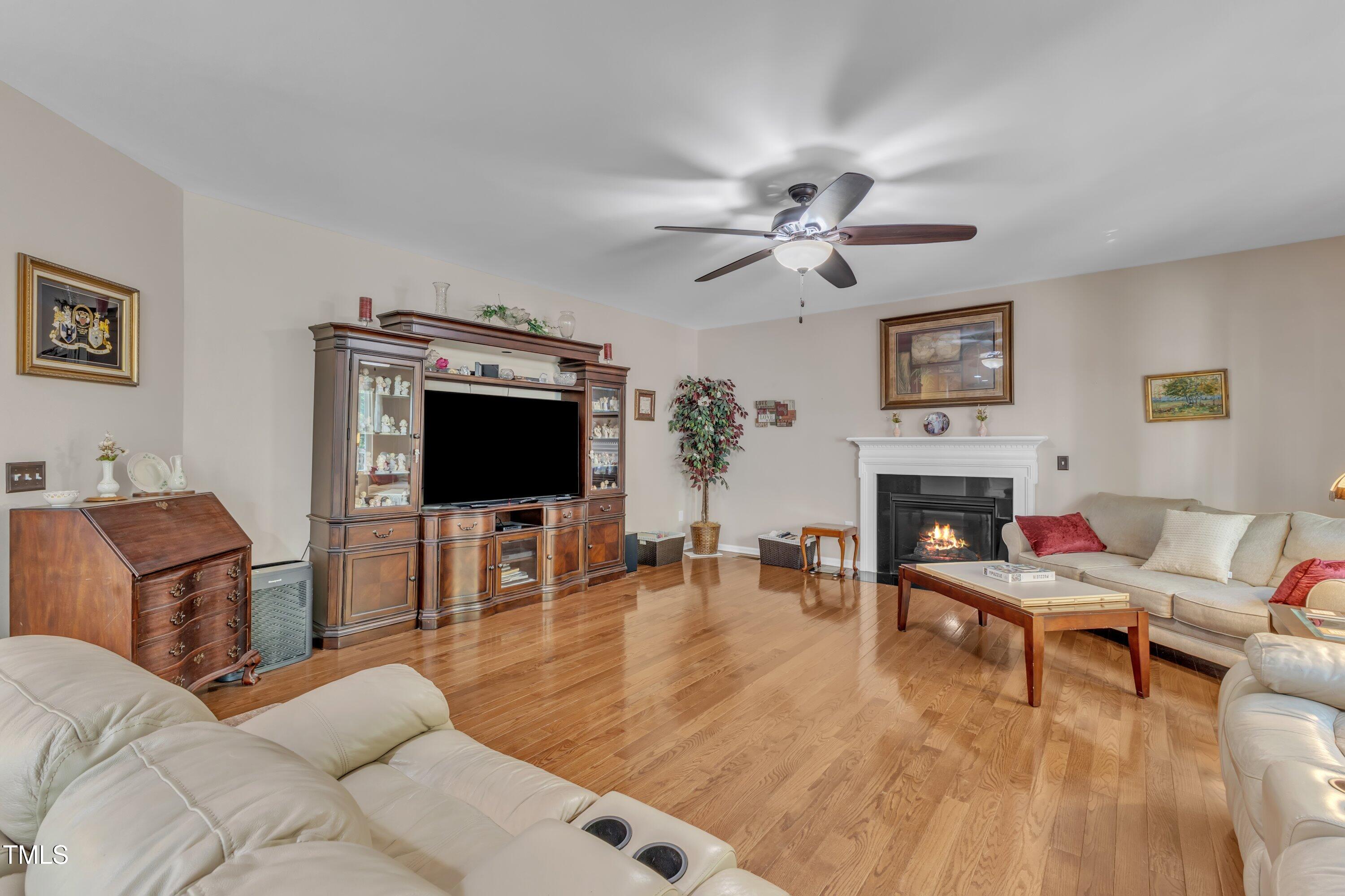 533 Opposition Way Wake Forest, NC 27587 - Photo 21 of 87 a living room with furniture fireplace and a flat screen tv