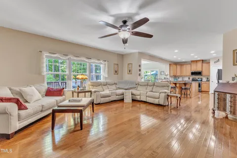 a dining room with furniture a chandelier and wooden floor