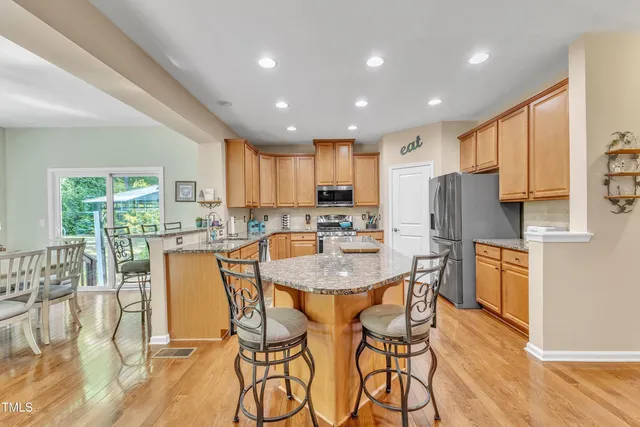 a living room with furniture a ceiling fan a fireplace and a window