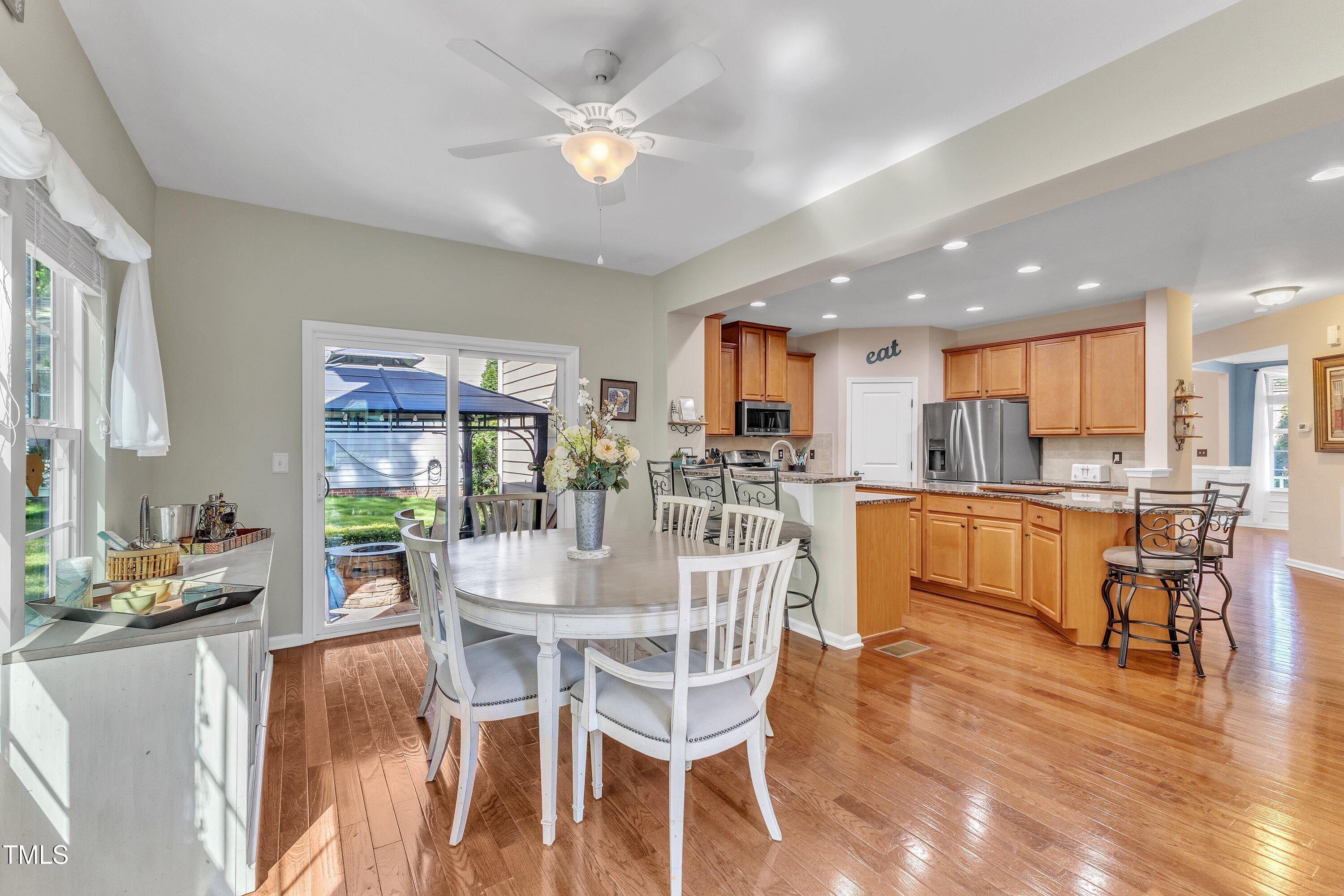 533 Opposition Way Wake Forest, NC 27587 - Photo 31 of 87 a dining room with stainless steel appliances kitchen island granite countertop a dining table chairs and granite counter top