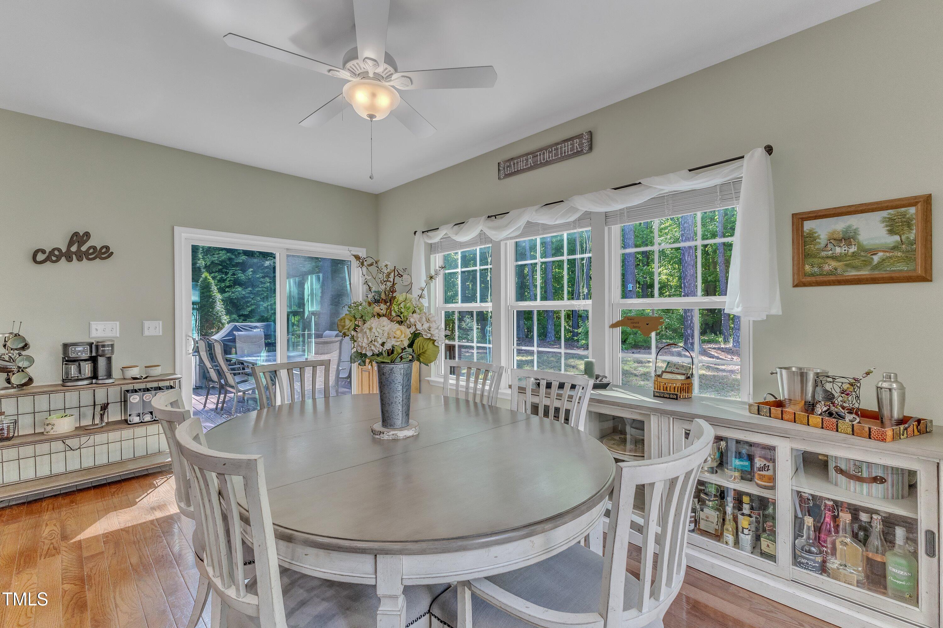 533 Opposition Way Wake Forest, NC 27587 - Photo 32 of 87 a dining room with furniture a chandelier and wooden floor