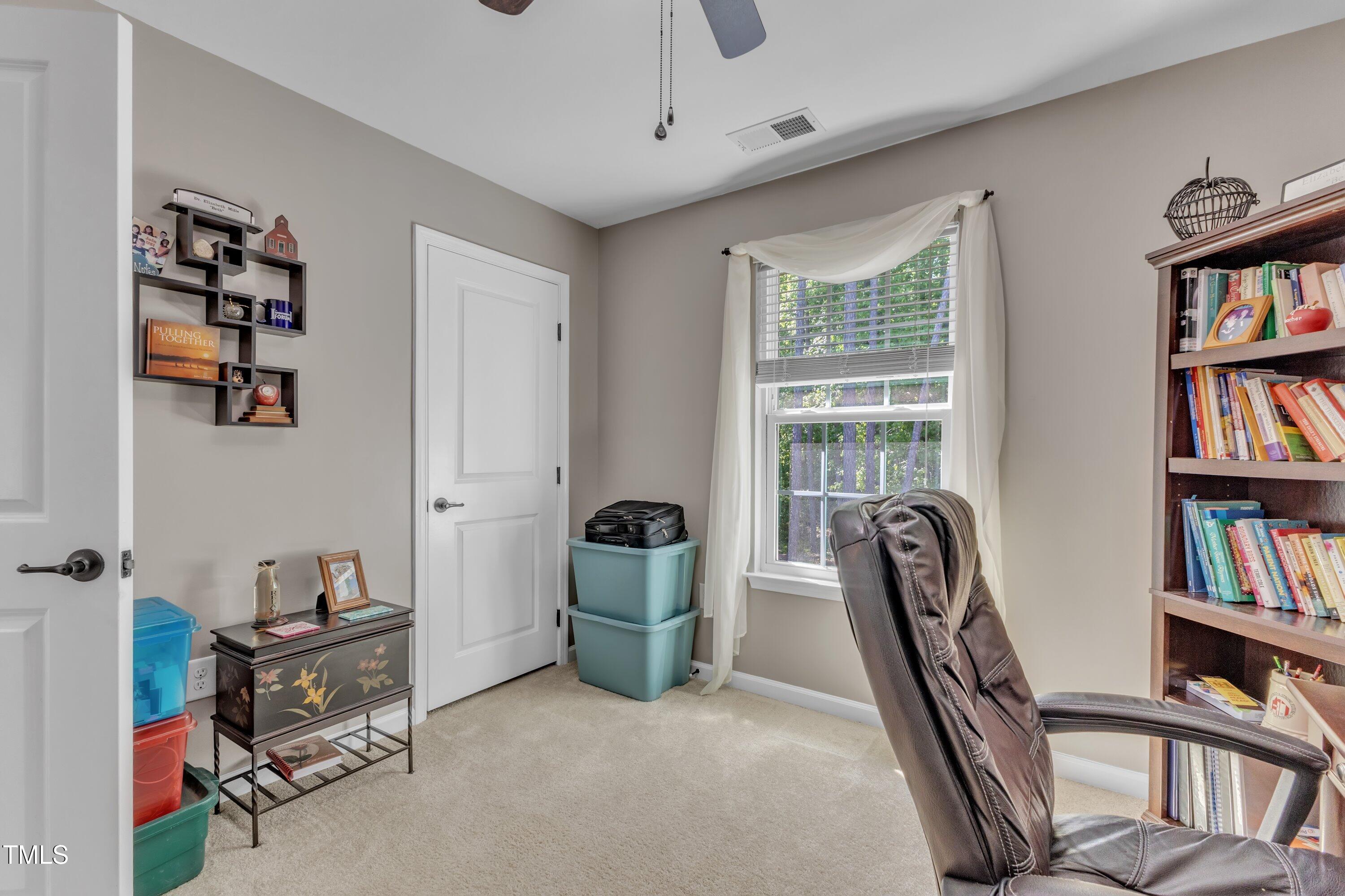 533 Opposition Way Wake Forest, NC 27587 - Photo 42 of 87 a view of a workspace with furniture and a book shelf