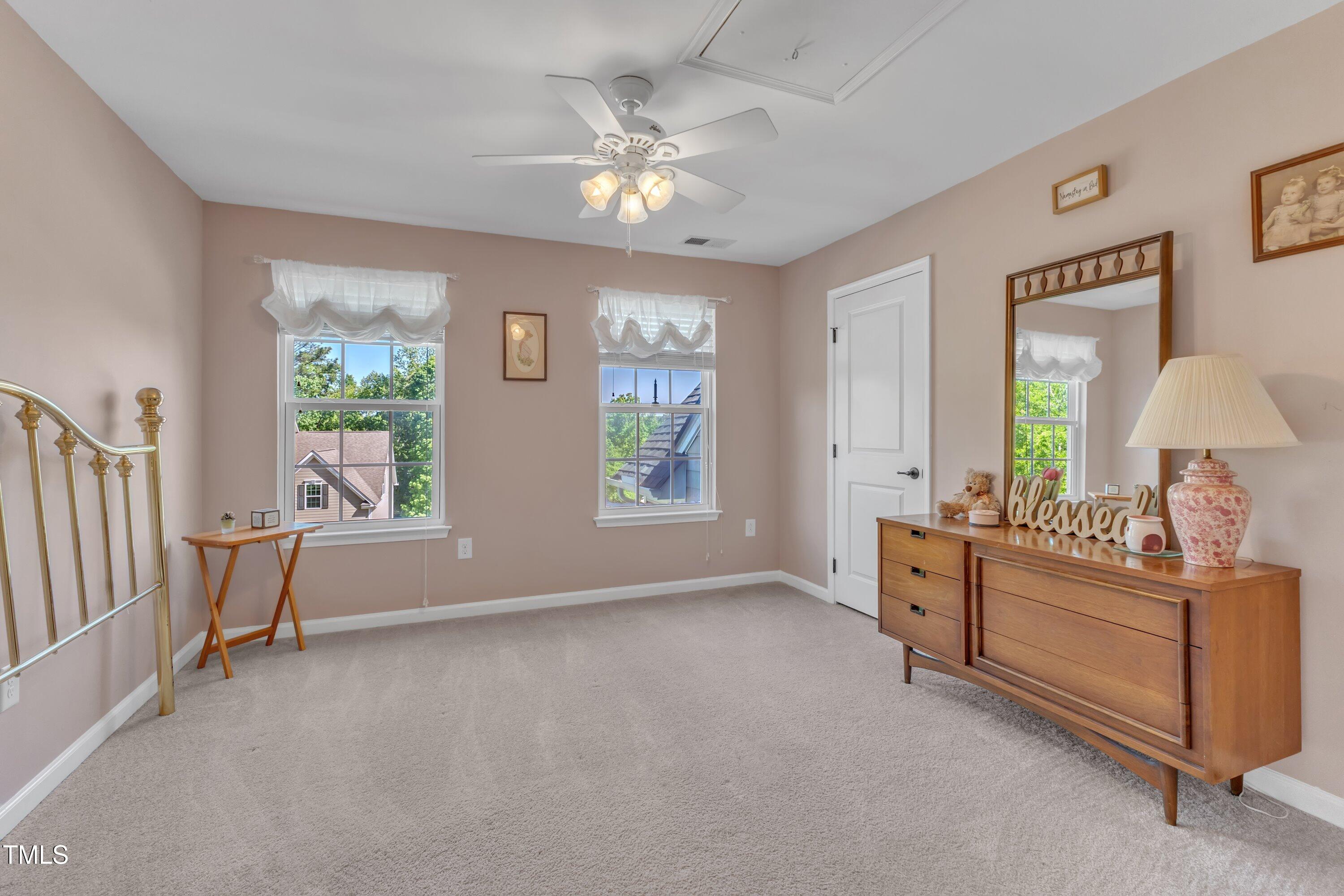 533 Opposition Way Wake Forest, NC 27587 - Photo 44 of 87 a spacious bedroom with a bed and a chandelier