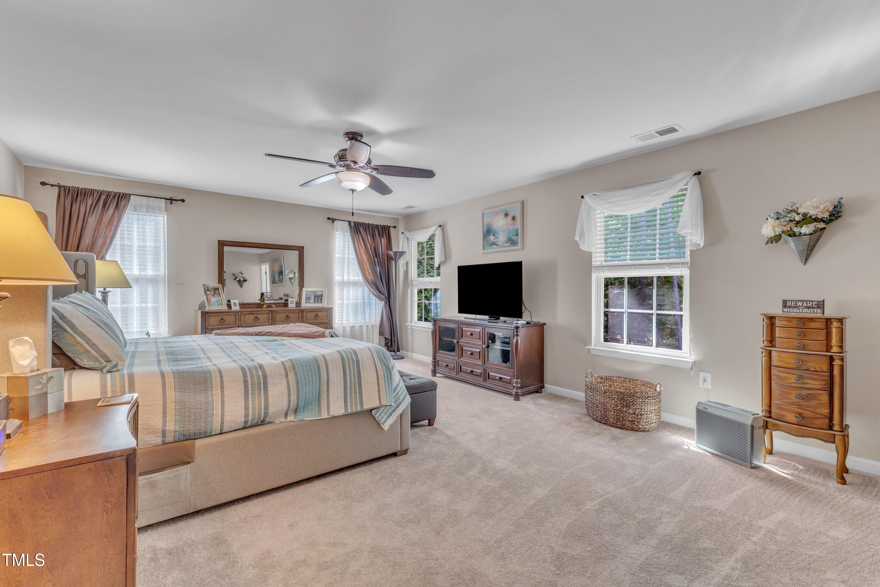 533 Opposition Way Wake Forest, NC 27587 - Photo 47 of 87 a spacious bedroom with a bed and a flat screen television