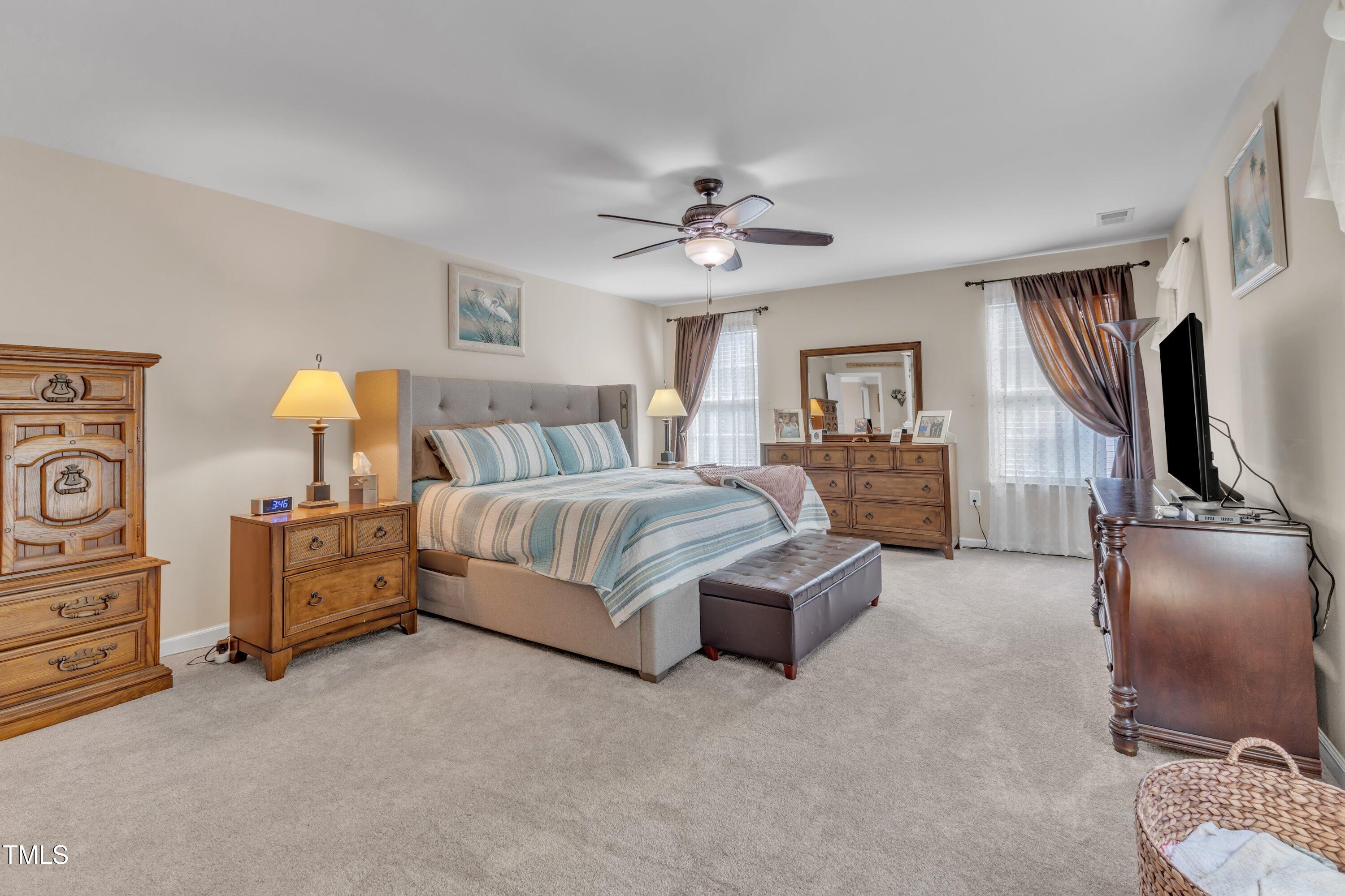 533 Opposition Way Wake Forest, NC 27587 - Photo 48 of 87 a bedroom with a bed and a chandelier