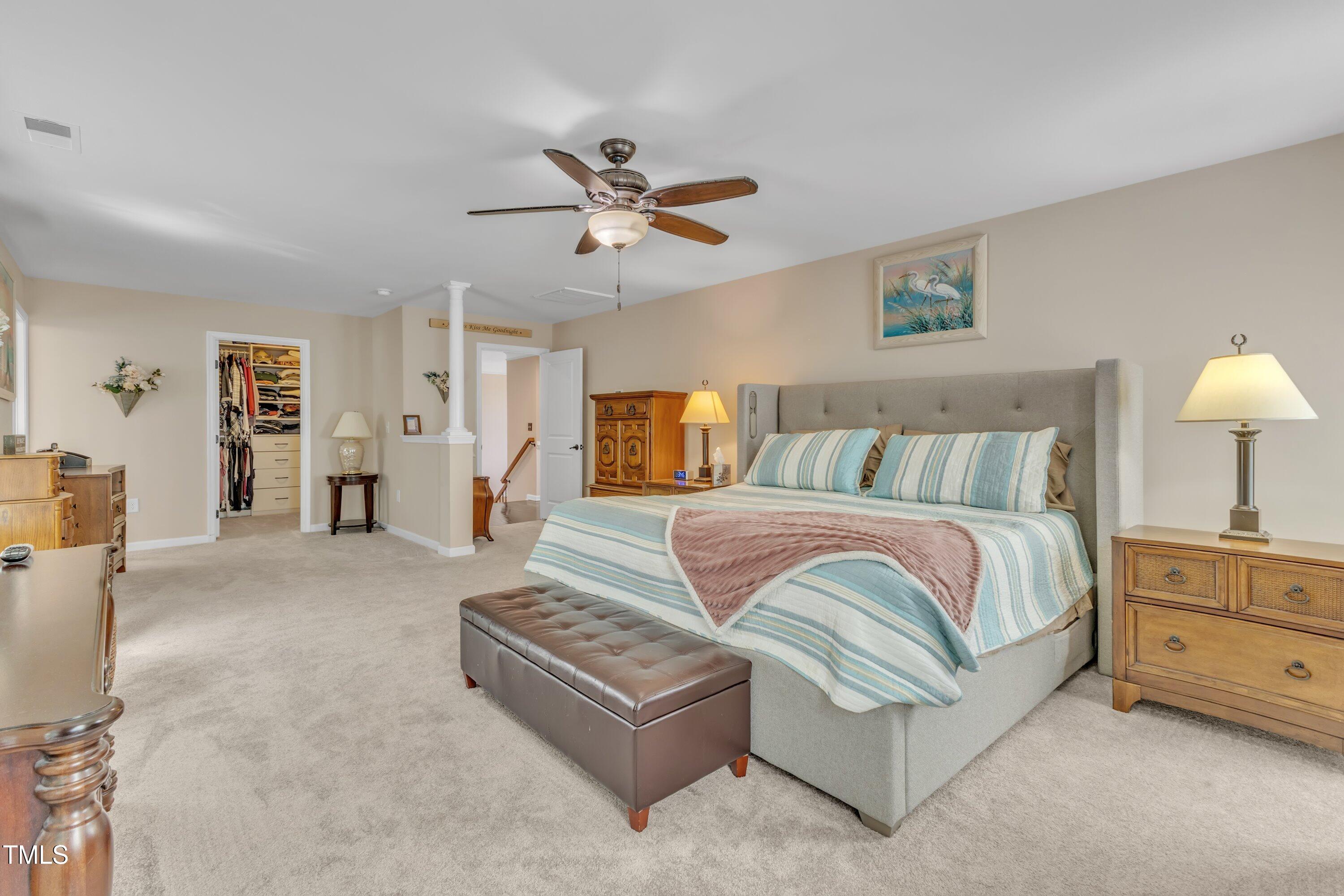 533 Opposition Way Wake Forest, NC 27587 - Photo 49 of 87 a spacious bedroom with a bed and ceiling fan