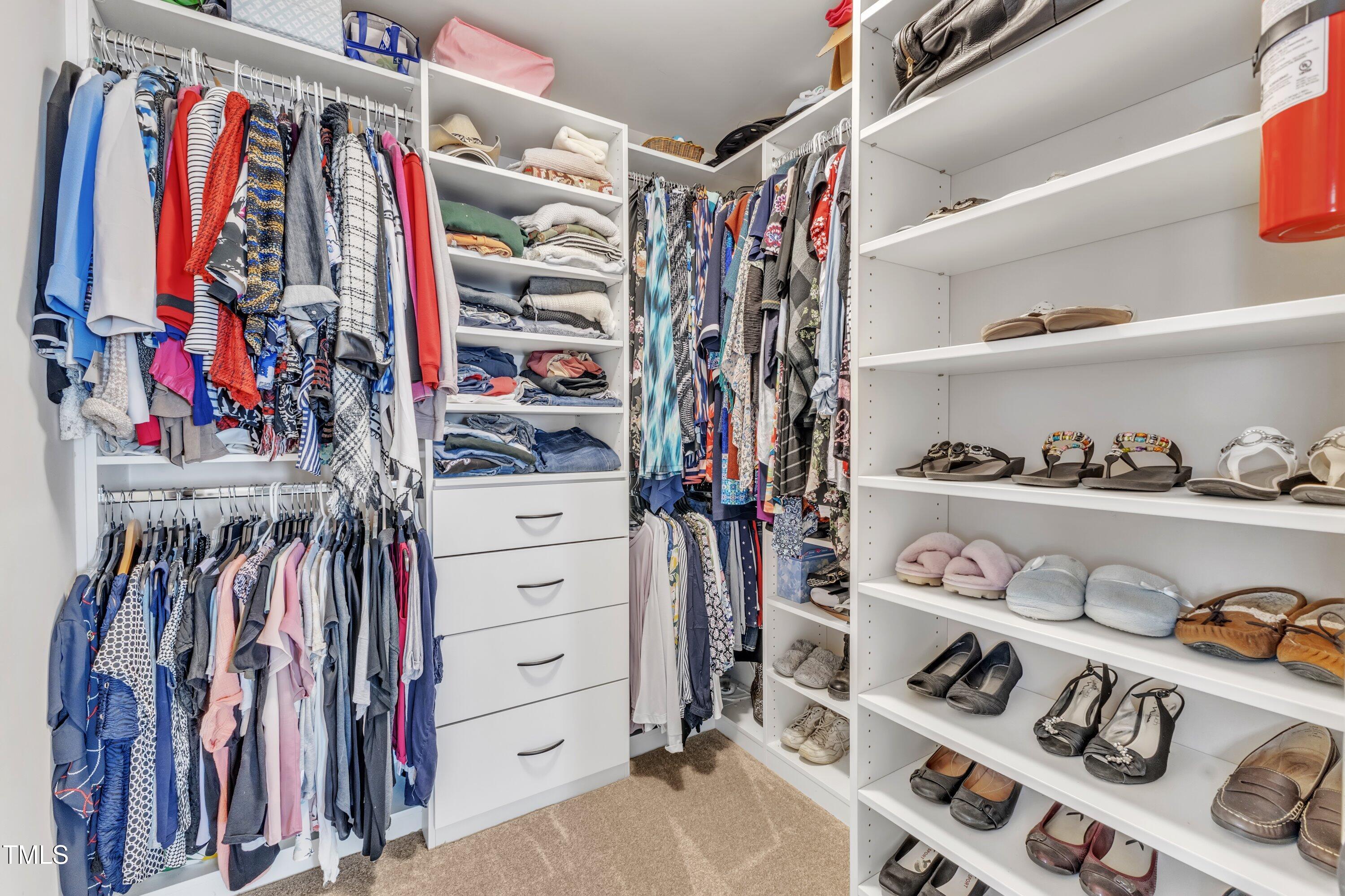 533 Opposition Way Wake Forest, NC 27587 - Photo 53 of 87 a view of walk in closet with clothes and shoes