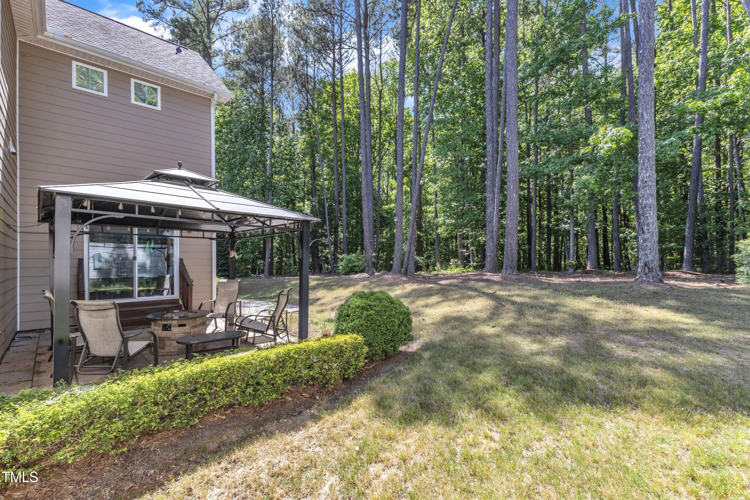 533 Opposition Way Wake Forest, NC 27587 - Photo 71 of 87 a view of a patio with table and chairs under an umbrella