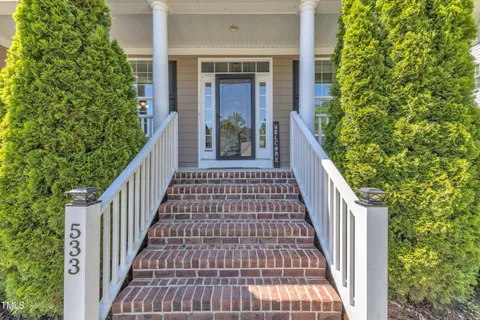 a view of a porch with furniture and a yard