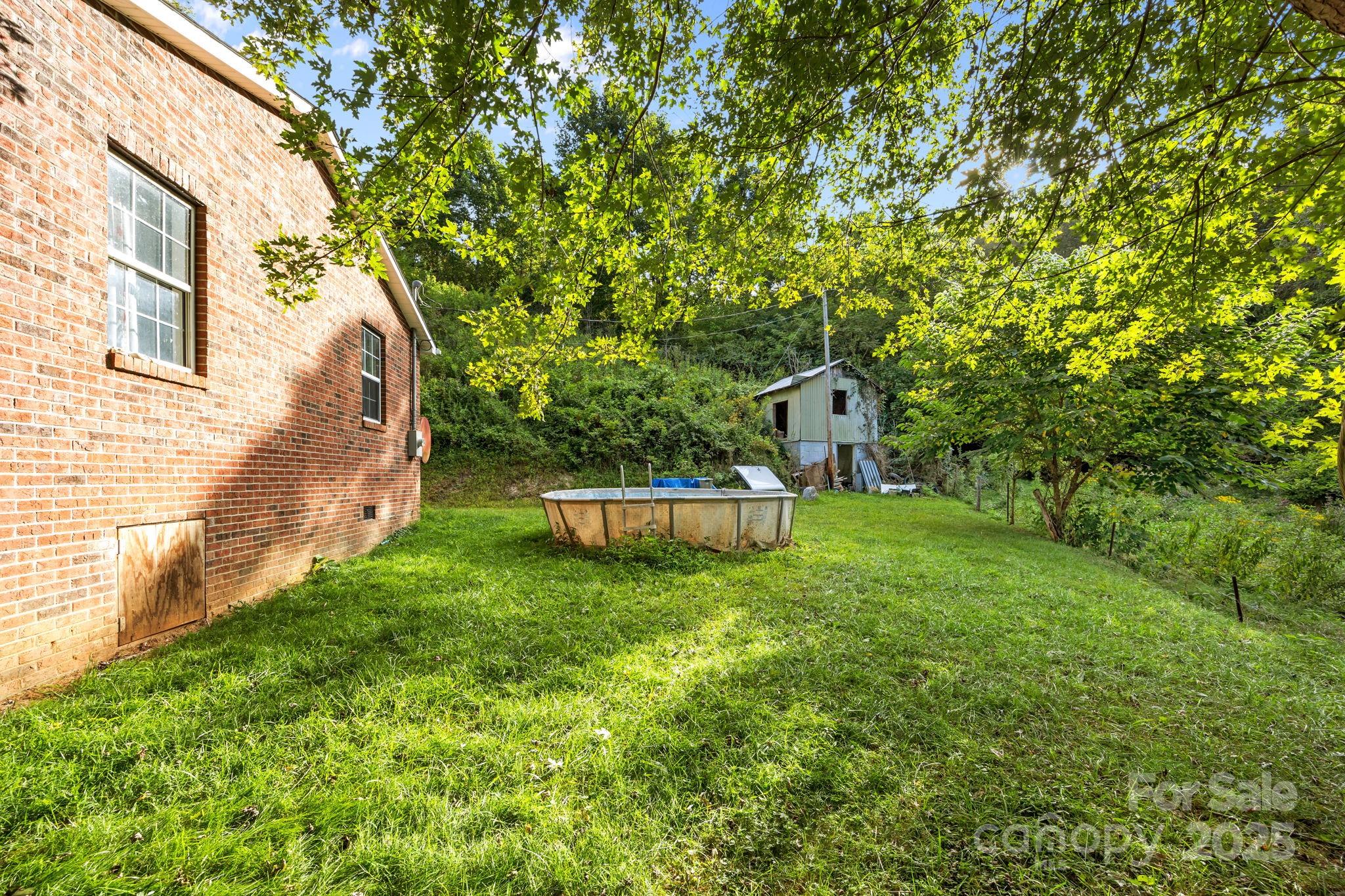 590 Sweet Water Road Marshall, NC 28753 - Photo 5 of 17 a view of a back yard