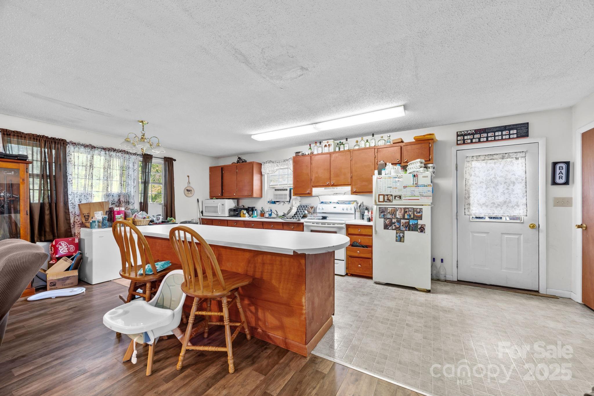 590 Sweet Water Road Marshall, NC 28753 - Photo 6 of 17 a kitchen with a table and chairs in it
