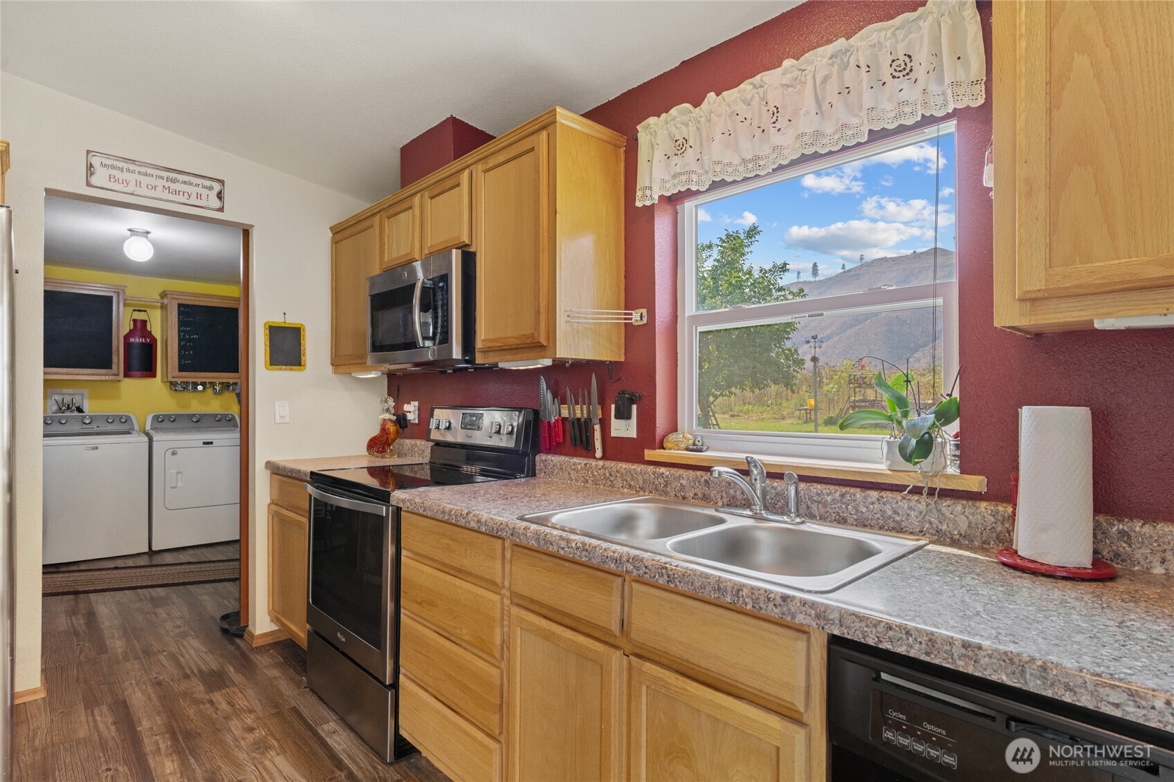 2560 Antoine Creek Road Chelan, WA 98816 - Photo 15 of 38 a kitchen with stainless steel appliances granite countertop a sink stove and wooden cabinets