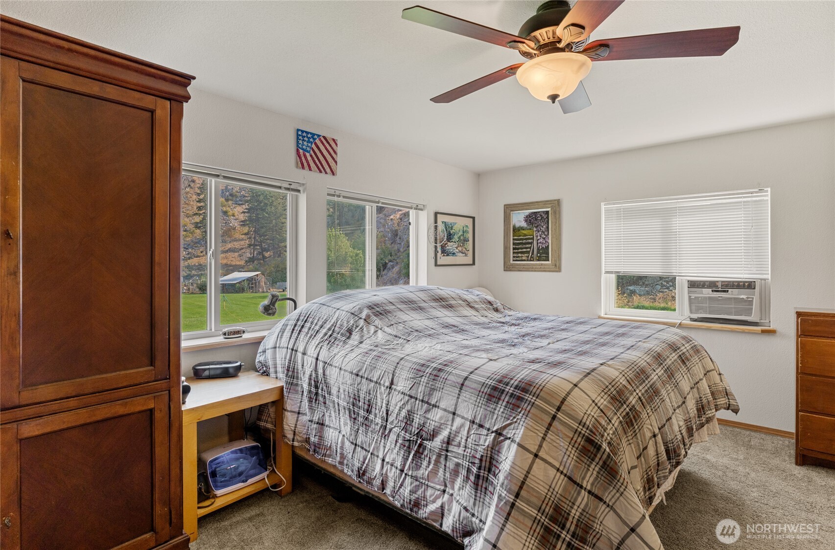 2560 Antoine Creek Road Chelan, WA 98816 - Photo 20 of 38 a bedroom with a bed and a chandelier