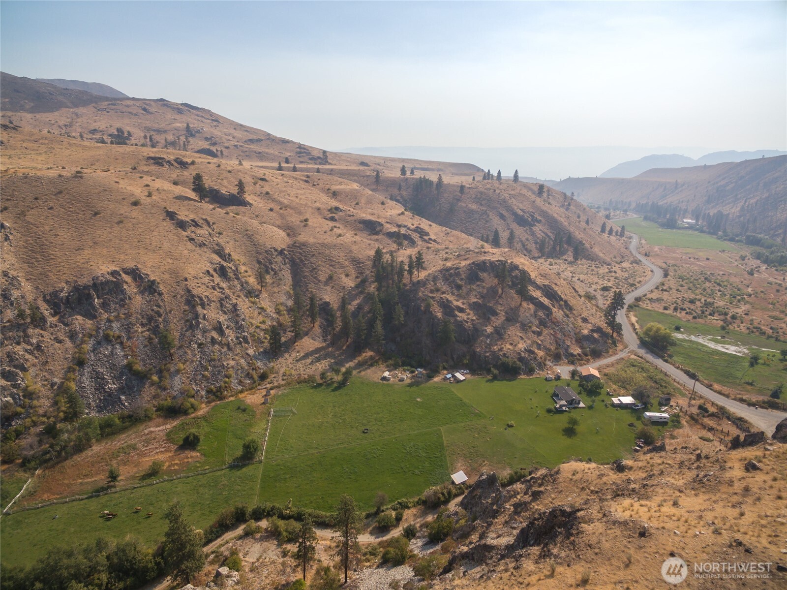 2560 Antoine Creek Road Chelan, WA 98816 - Photo 23 of 38 a view of a field with mountains in the background