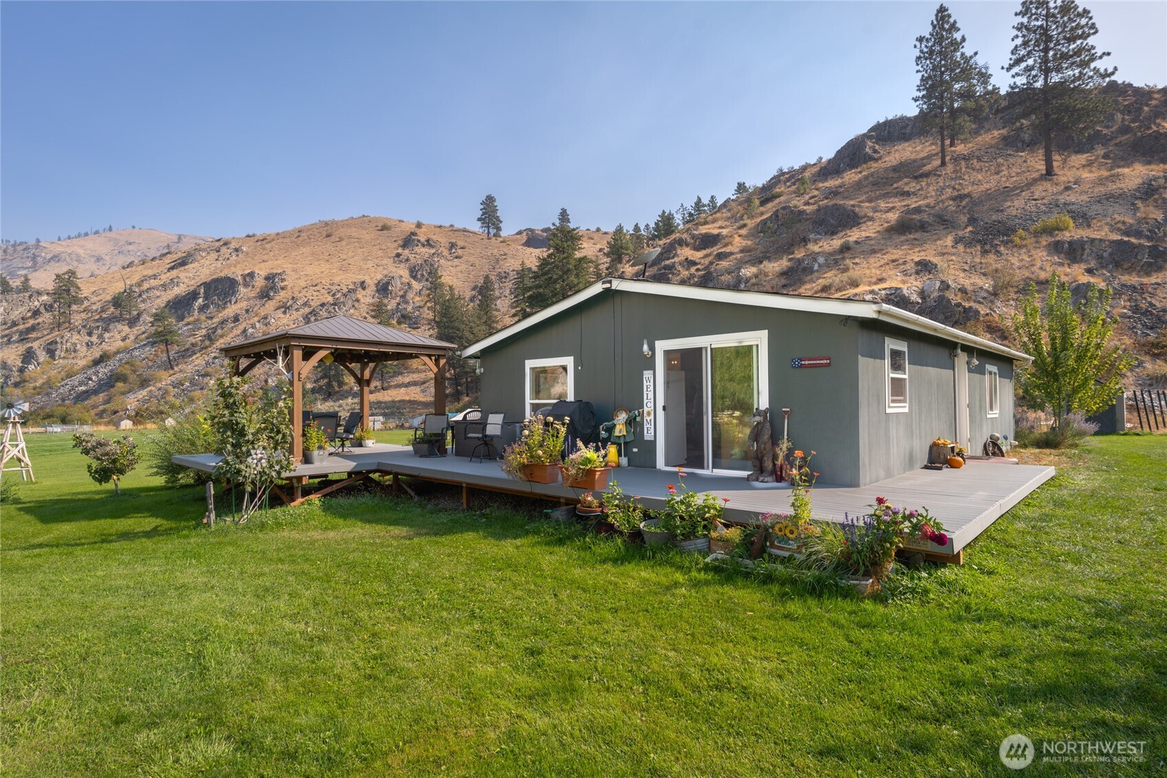 2560 Antoine Creek Road Chelan, WA 98816 - Photo 5 of 38 a view of a house with backyard porch and sitting area