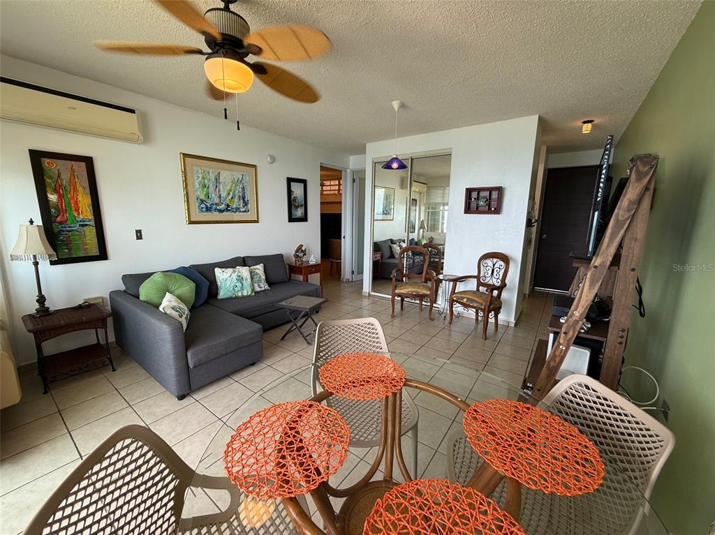 Condo Pelican Reef Condo Pelican Reef, Unit 302 Rincon, PR 00677 - Photo 3 of 16 a living room with furniture and wooden floor