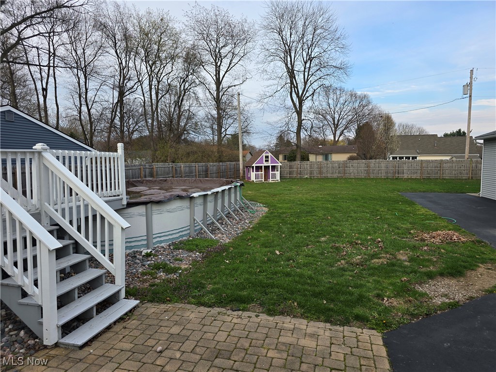 167 Birch Road Painesville, OH 44077 - Photo 44 of 49 View of yard with a fenced in pool, an outbuilding, a fenced backyard, stairs, and a deck