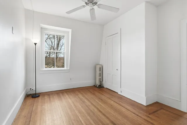 a room with a table chairs and a large window