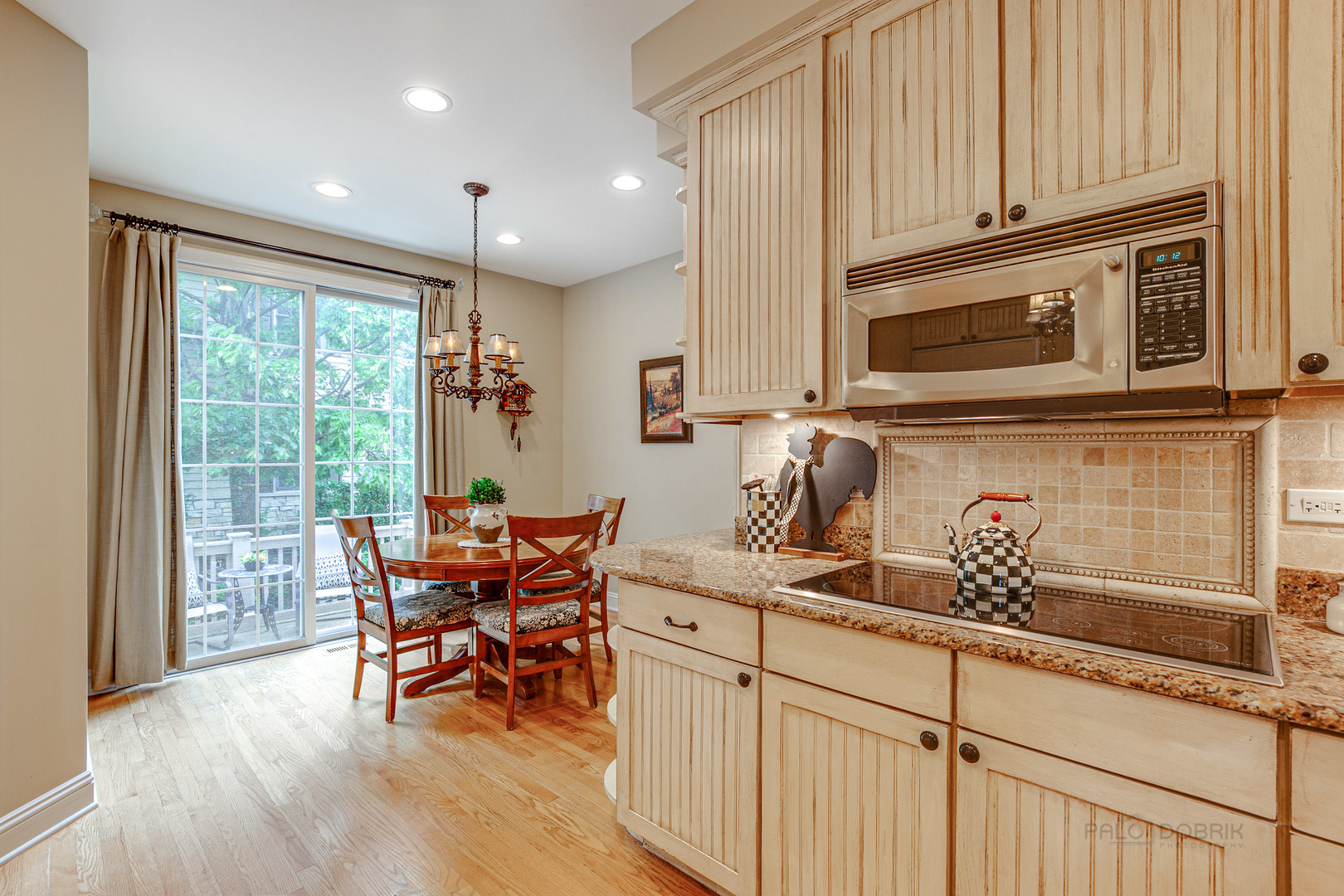 920 Symphony Drive Lake Forest, IL 60045 - Photo 12 of 28 a kitchen with stainless steel appliances granite countertop a stove top oven a sink with granite countertops and cabinets
