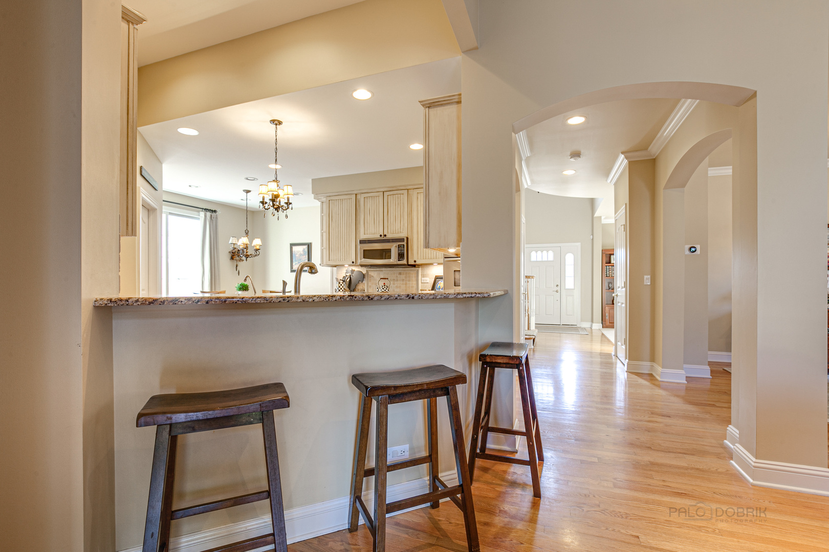 920 Symphony Drive Lake Forest, IL 60045 - Photo 14 of 28 a kitchen with stainless steel appliances granite countertop wooden floor window and cabinets