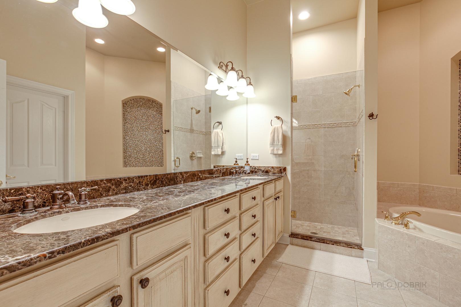 920 Symphony Drive Lake Forest, IL 60045 - Photo 17 of 28 a bathroom with a granite countertop double vanity sink mirror and shower