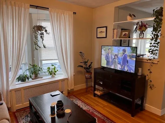 a living room with furniture and flowers