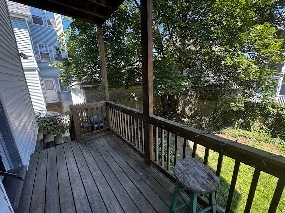 a view of balcony with wooden floor and outdoor seating
