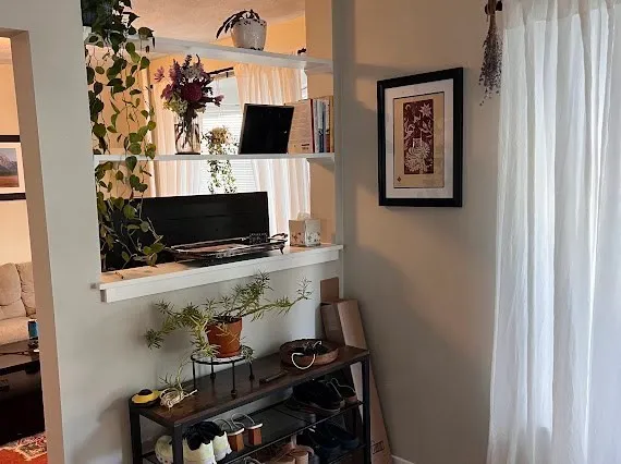 a living room with a flat screen tv and a wall painting