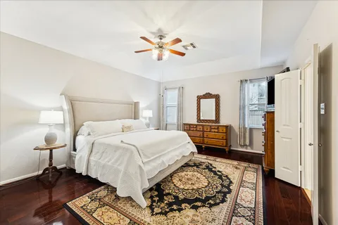 a bedroom with a bed and wooden floor