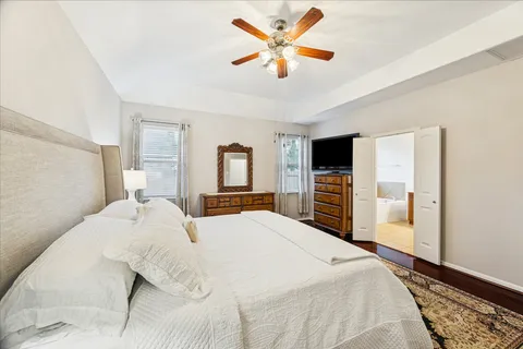 a bedroom with a large bed and a tv