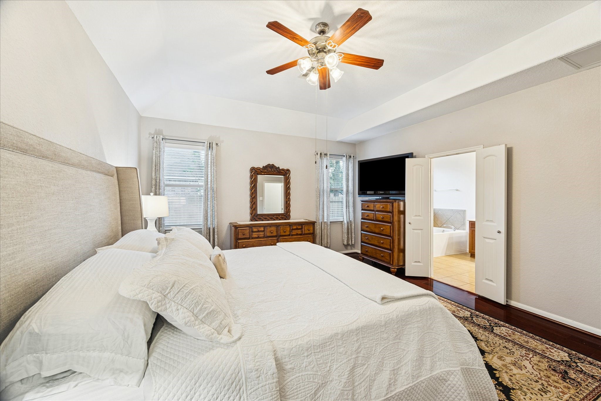 191 Maple Grove Drive Conroe, TX 77384 - Photo 16 of 31 a bedroom with a large bed and a tv