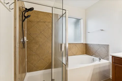 a bathroom with a bathtub and shower