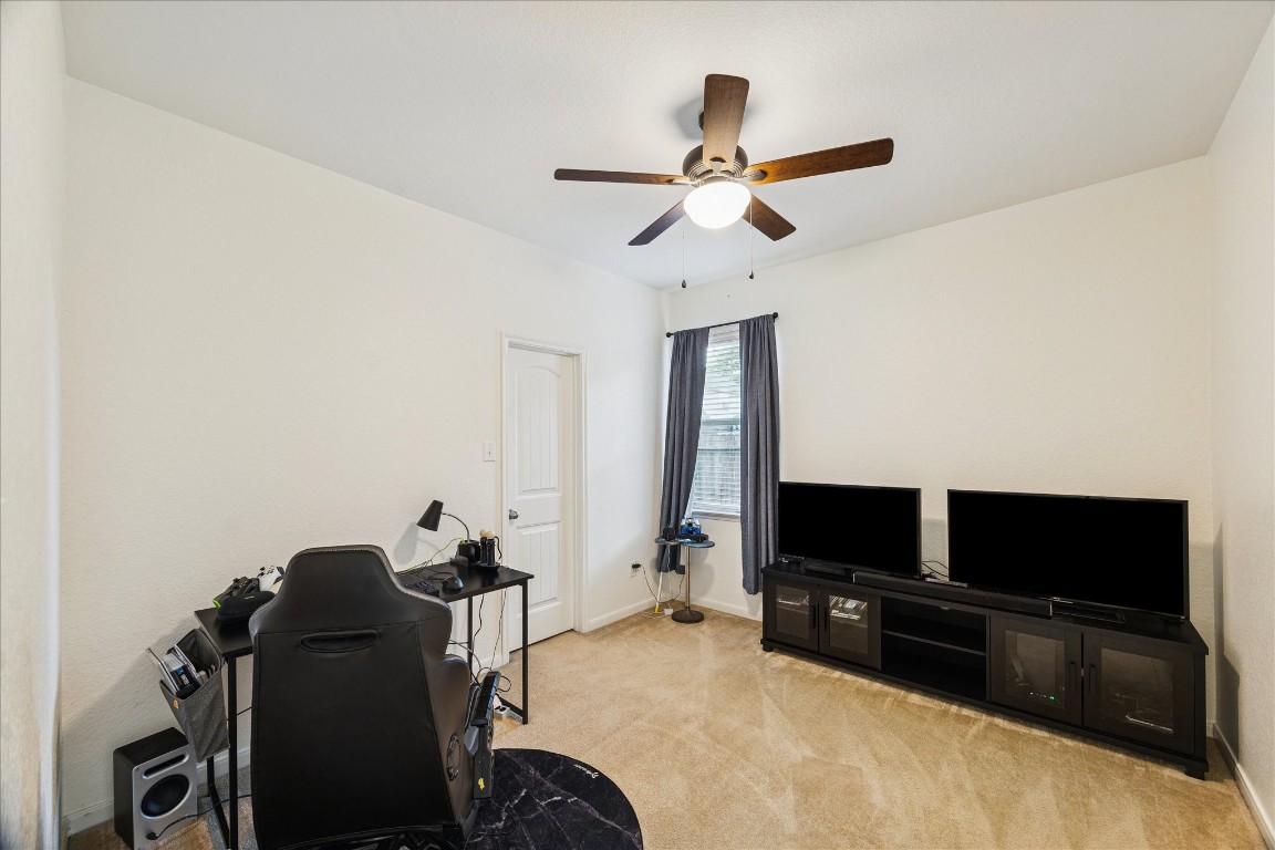 191 Maple Grove Drive Conroe, TX 77384 - Photo 22 of 31 a living room with furniture and a flat screen tv