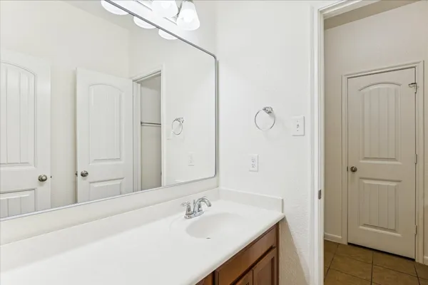 a bathroom with a sink vanity and mirror