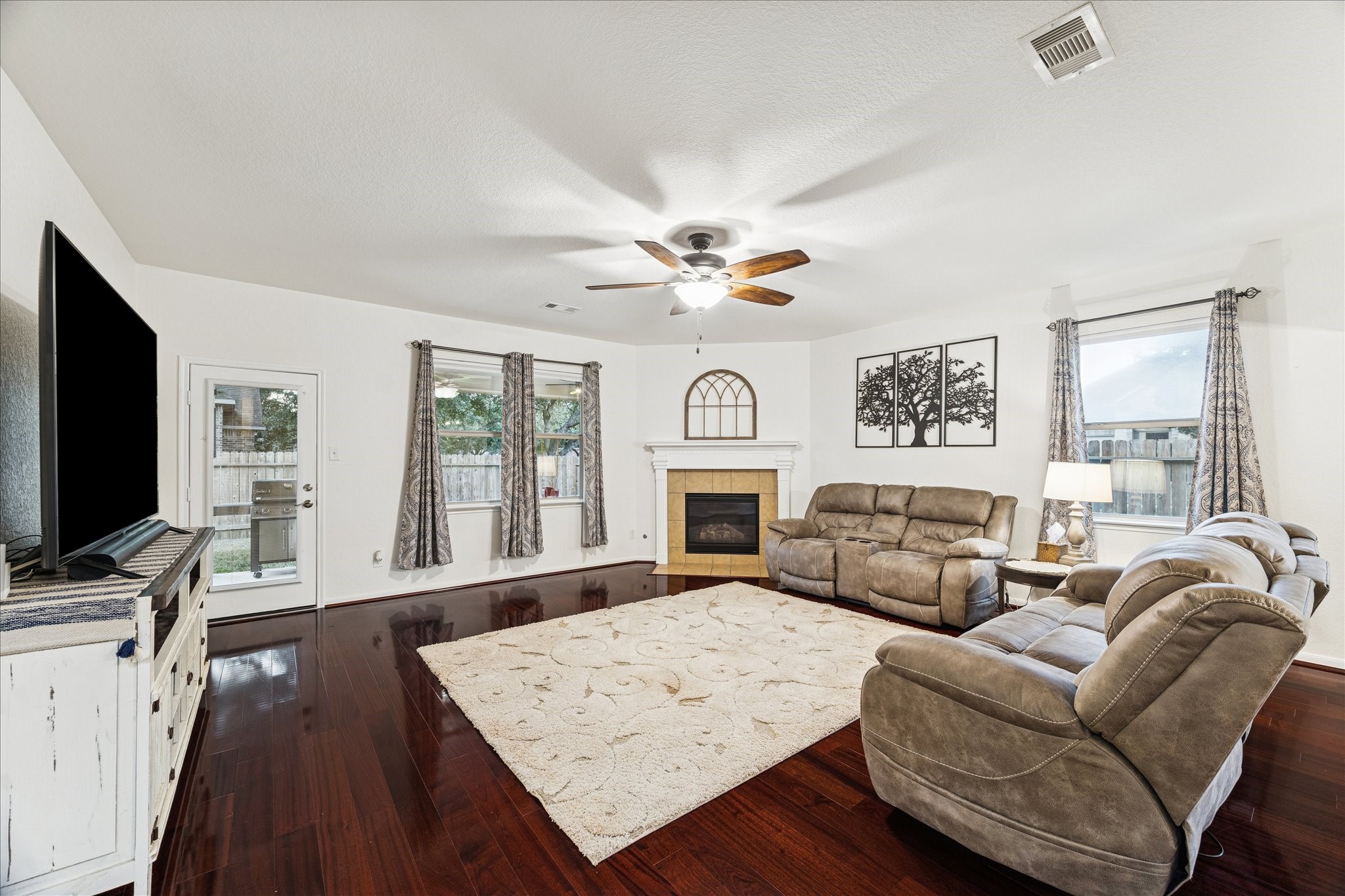 191 Maple Grove Drive Conroe, TX 77384 - Photo 5 of 31 a living room with furniture a fireplace and a flat screen tv