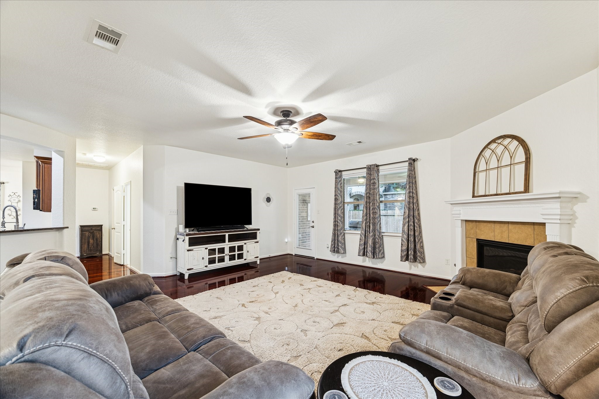 191 Maple Grove Drive Conroe, TX 77384 - Photo 7 of 31 a living room with furniture flat screen tv and a fireplace
