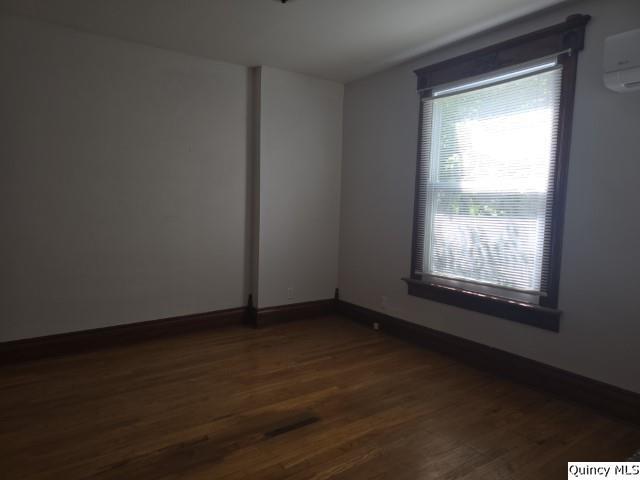 210 Main Street Carthage, IL 62321 - Photo 11 of 36 a view of an empty room with wooden floor and a window