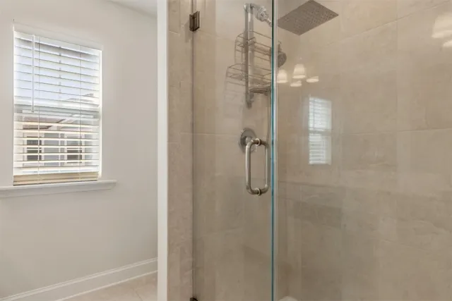 an empty room with a window and a ceiling fan