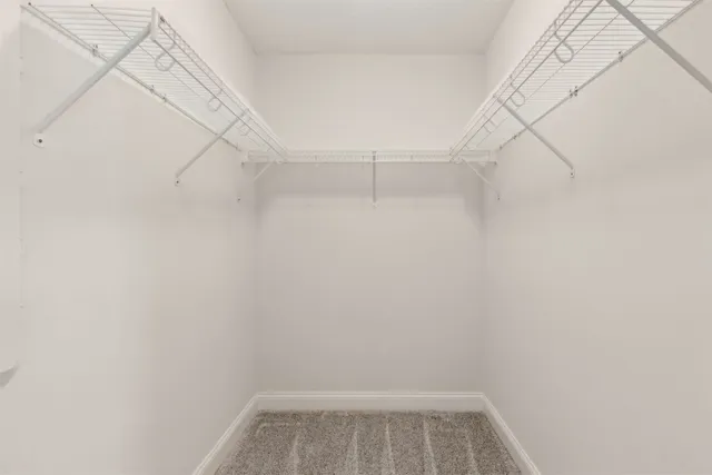 a bathroom with a sink a toilet a mirror and shower