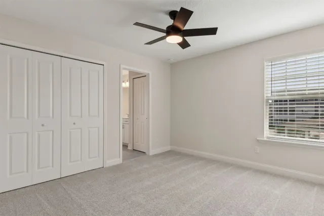 a bathroom with a granite countertop sink and a toilet