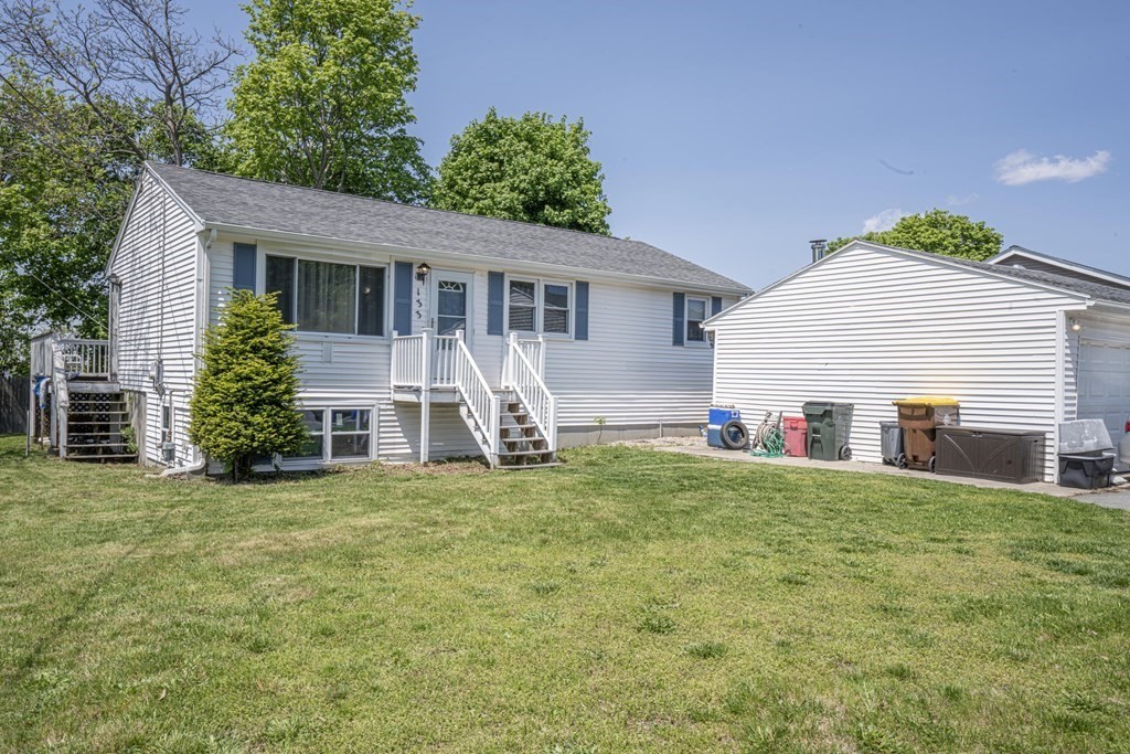 a view of a house with a yard and sitting area