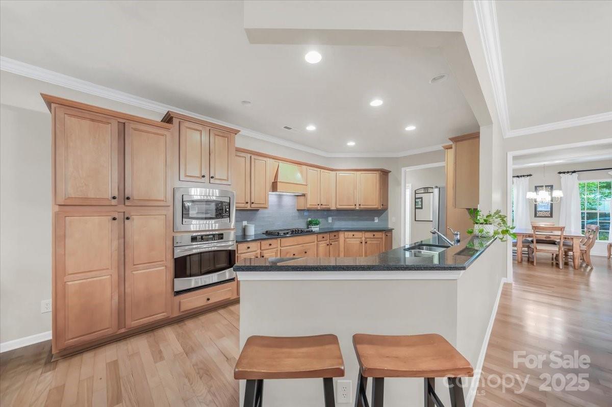 51225 Daffodil Court Fort Mill, SC 29707 - Photo 21 of 45 a kitchen with a table chairs refrigerator and cabinets