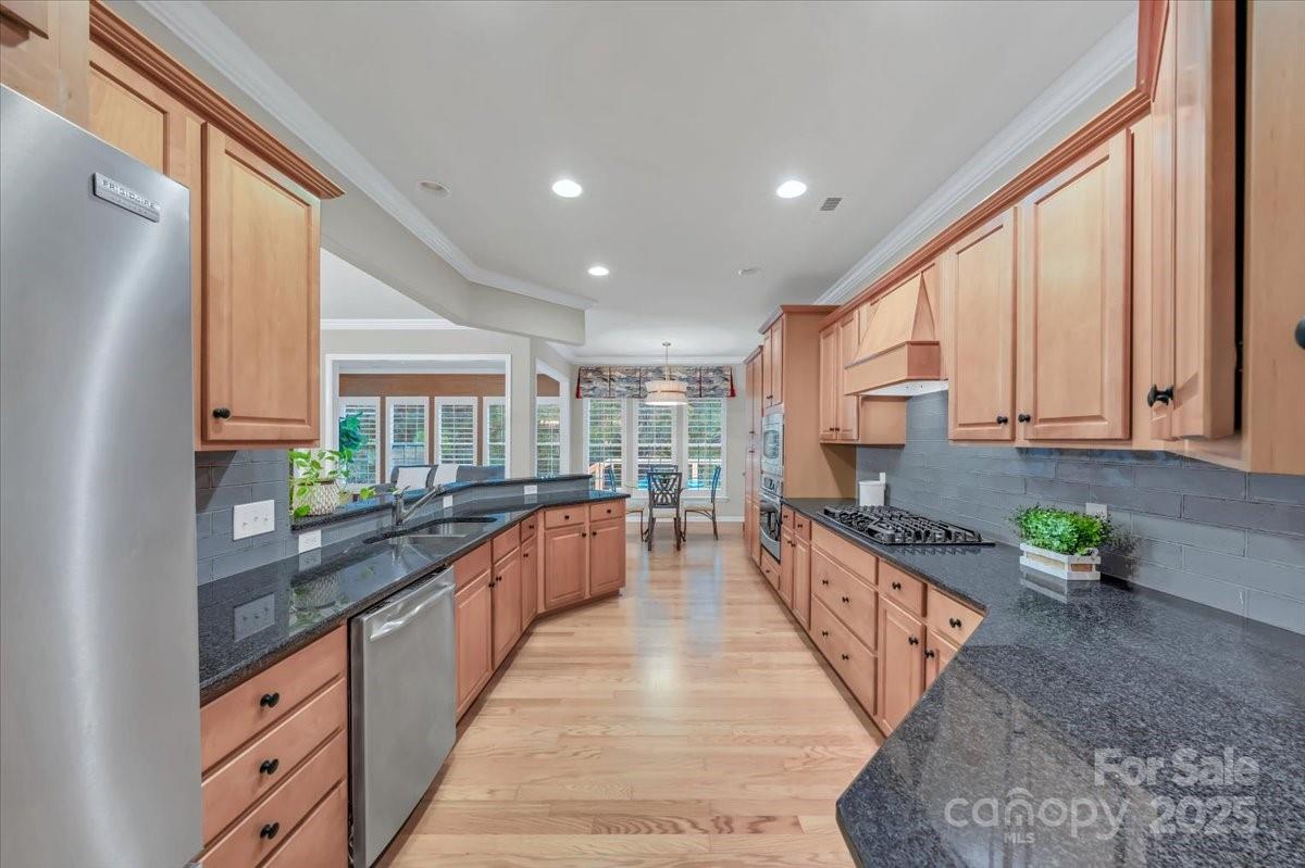 51225 Daffodil Court Fort Mill, SC 29707 - Photo 22 of 45 a large kitchen with stainless steel appliances granite countertop sink stove and cabinets