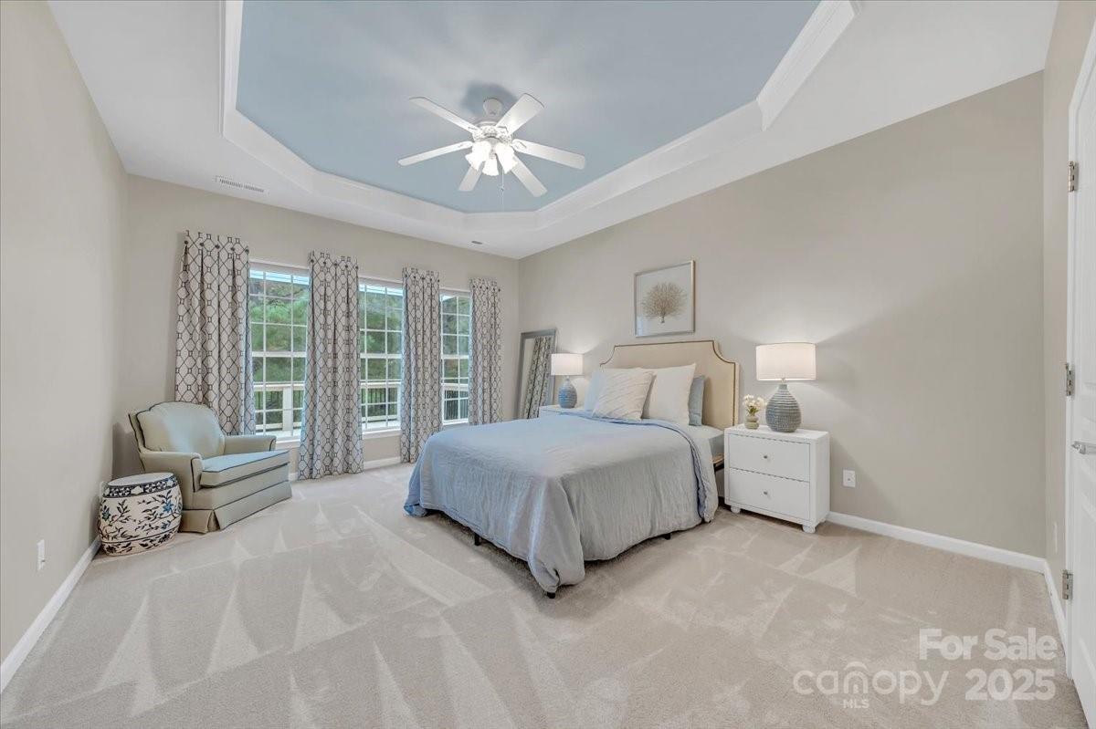 51225 Daffodil Court Fort Mill, SC 29707 - Photo 23 of 45 a spacious bedroom with a bed and ceiling fan