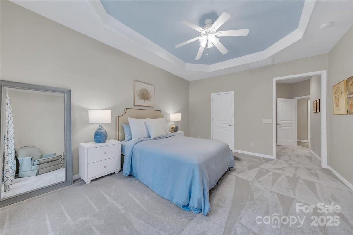 51225 Daffodil Court Fort Mill, SC 29707 - Photo 24 of 45 a bedroom with a large bed and a chandelier