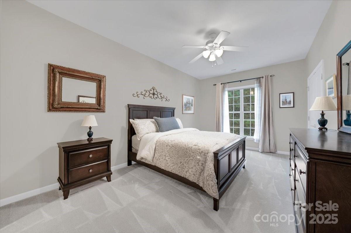 51225 Daffodil Court Fort Mill, SC 29707 - Photo 29 of 45 a bedroom with a bed and a chandelier