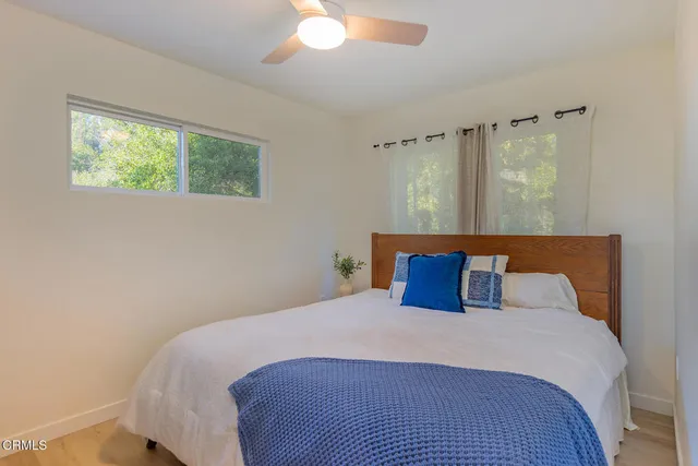 a bedroom with a large bed and a window