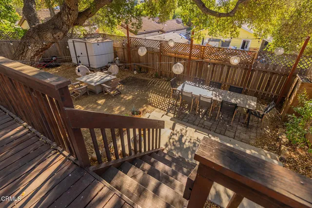 a view of a house with wooden fence