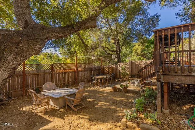 a view of a patio with iron fence